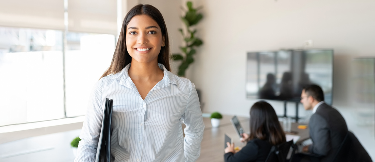 Professional woman smiles in conference room
