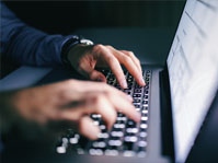 person typing on laptop